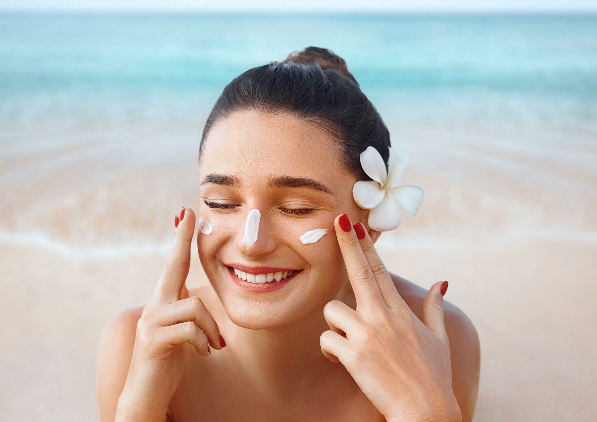 photo of a woman applying one of the best sunscreens for her acne prone skin